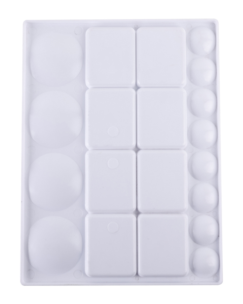 Close view of a plastic paint palette showing the layout of its square wells